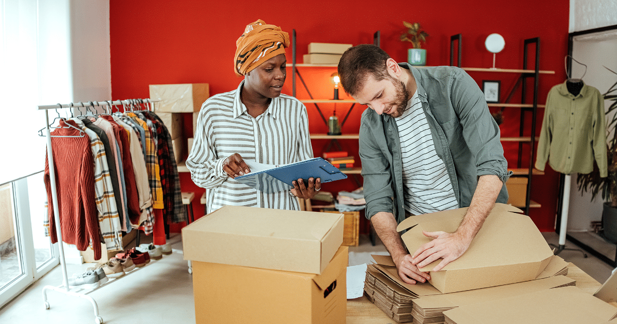 Business owners collaborating on inventory management in a retail space, highlighting flexible business loans for bad credit.