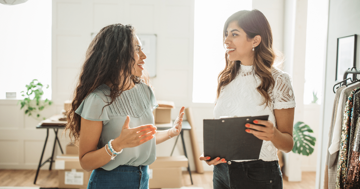 Two businesswomen discussing innovative cash advance solutions in a modern office setting.