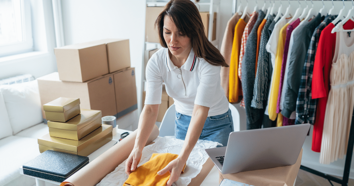 Woman packing clothing for an online business, showcasing equipment leasing and financing for growth opportunities.