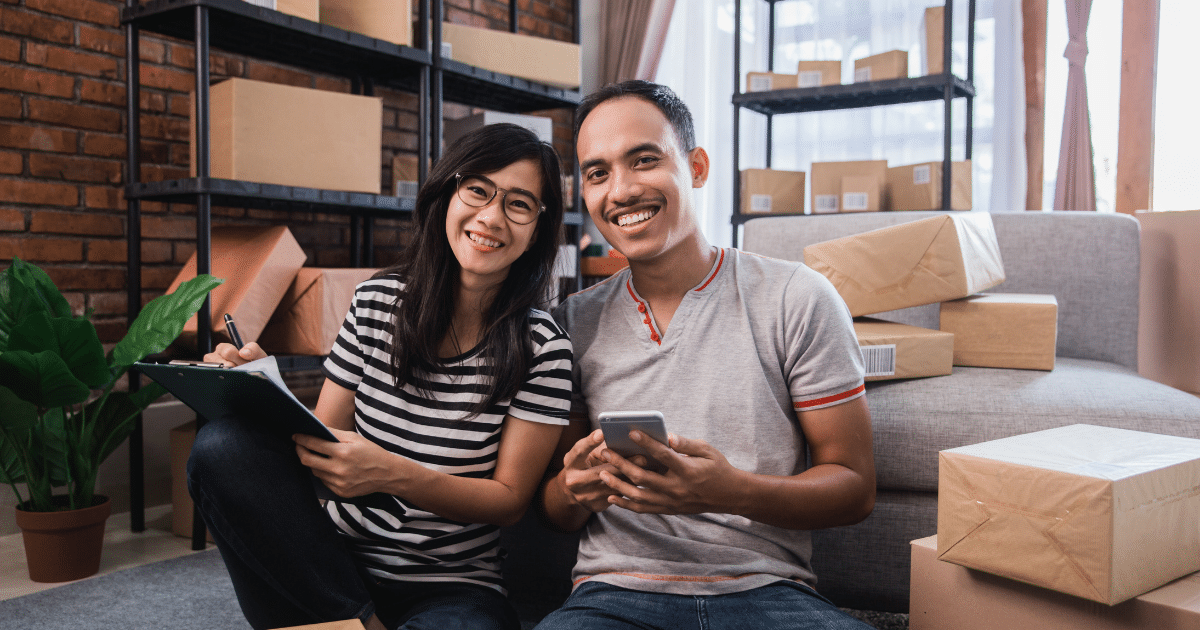 Small business owners planning for success, managing finances, and avoiding pitfalls in a home office setting.