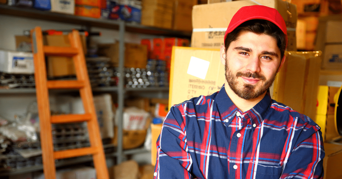 Small business owner in a warehouse, showcasing productivity and leadership, emphasizing the benefits of taking vacations.