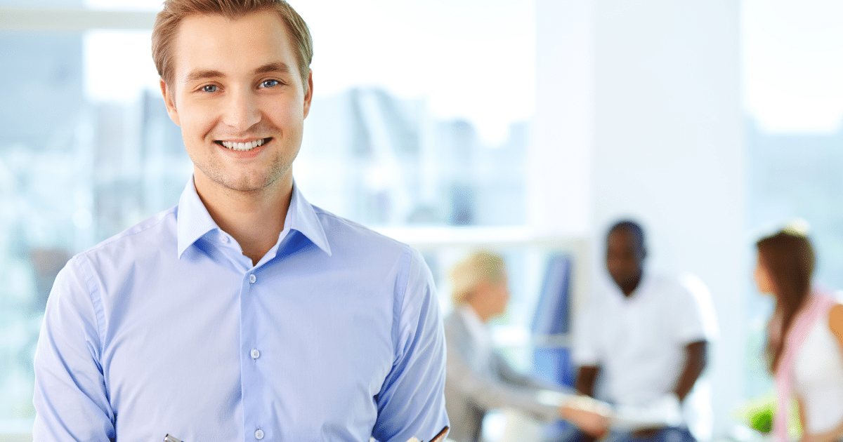 Smiling professional in a business setting, representing effective lead generation and marketing strategies.