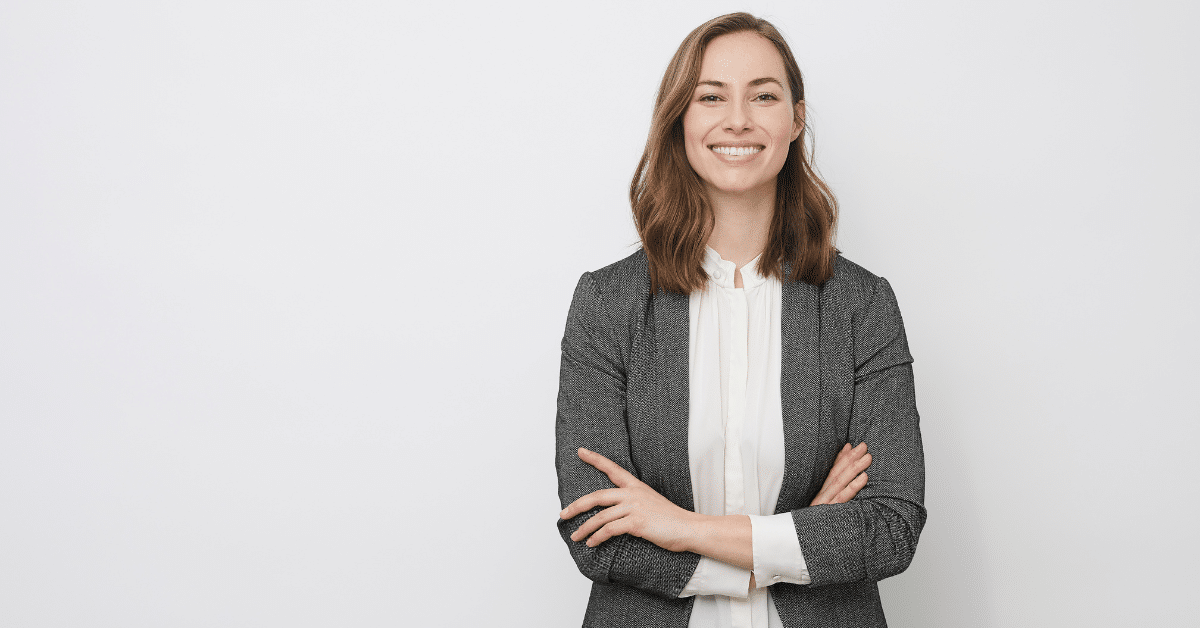 Business professional smiling confidently, representing networking and success at trade shows for brand visibility.