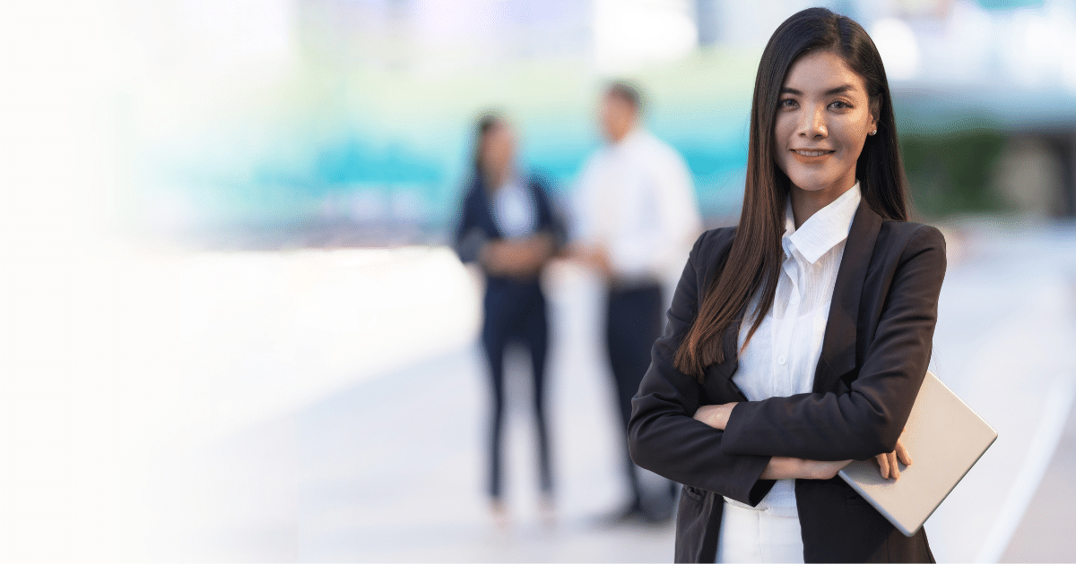 Professional woman in business attire with a tablet, representing expert media consulting for business growth.