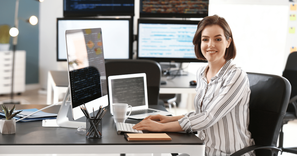Business owner at a desk with computers, emphasizing corporate liability and asset protection strategies.