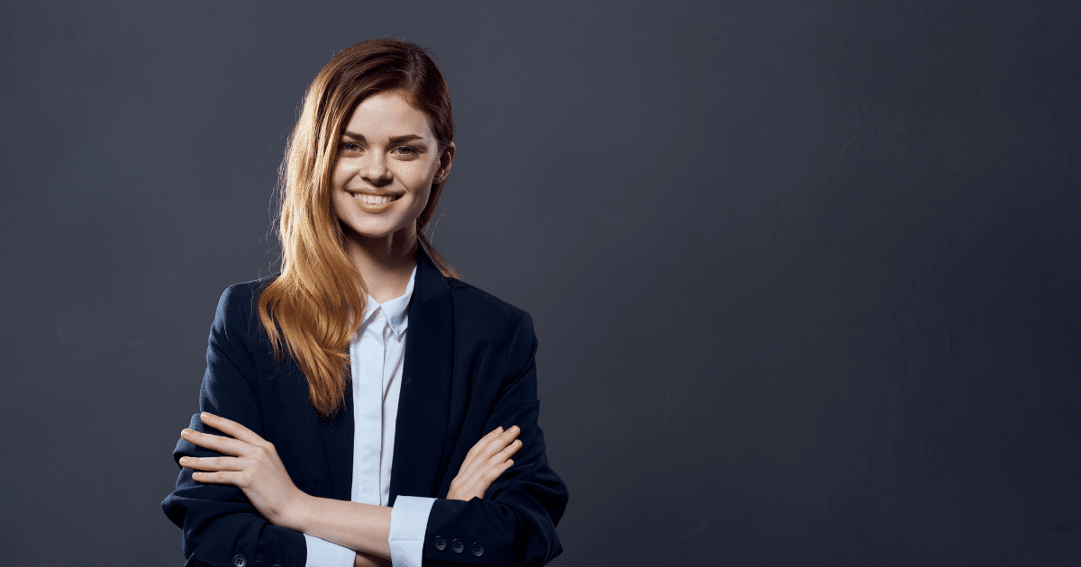 Smiling businesswoman in a suit, representing financial success and avoiding common pitfalls in business management.