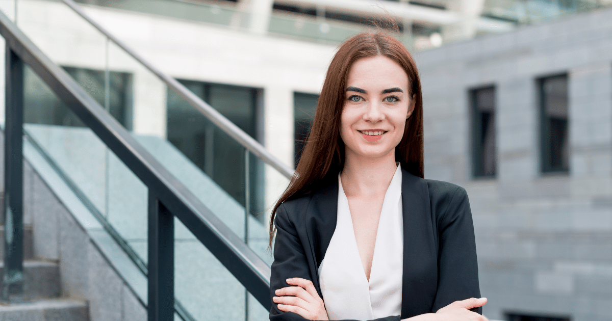 Professional woman smiling confidently outdoors, representing effective strategies for managing negative social media reviews.