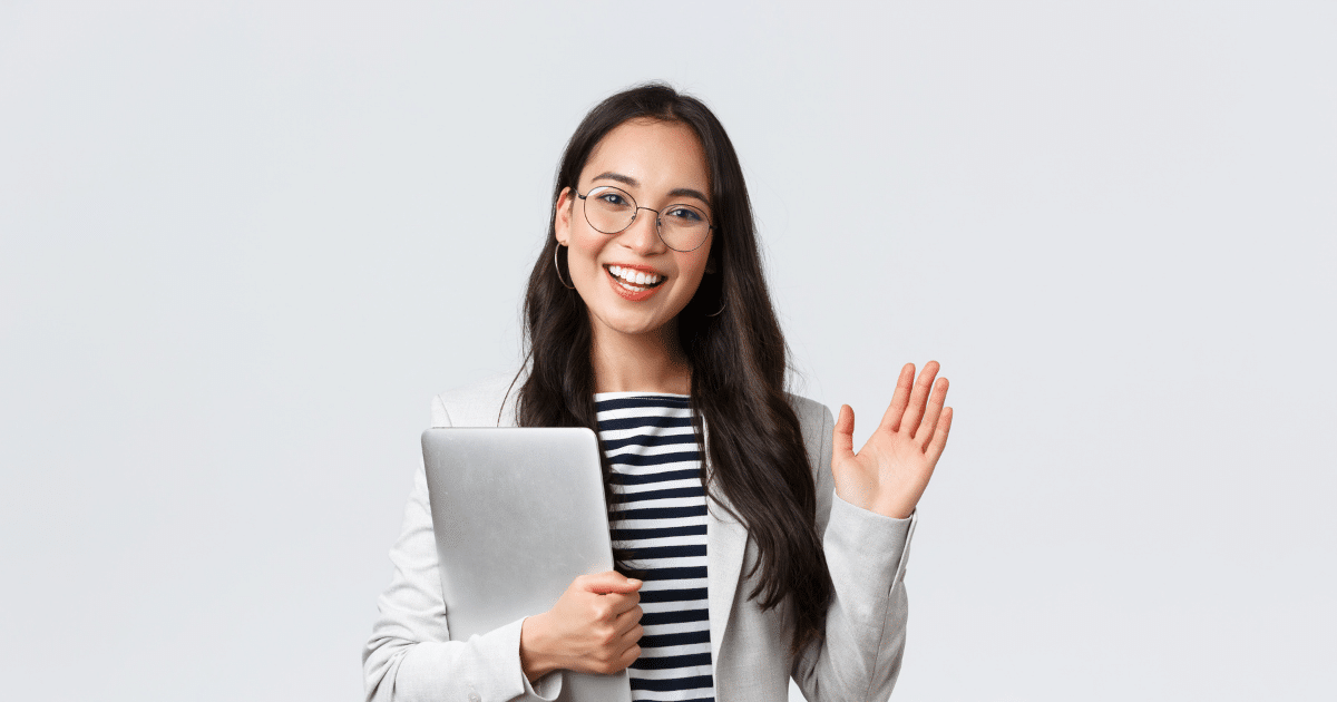 Smiling businesswoman with a laptop, representing financial success and smart business management strategies.