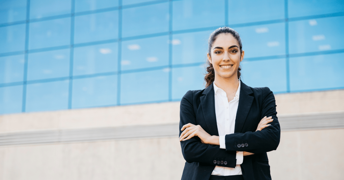Businesswoman in a suit smiling confidently, representing effective marketing automation strategies for small business success.