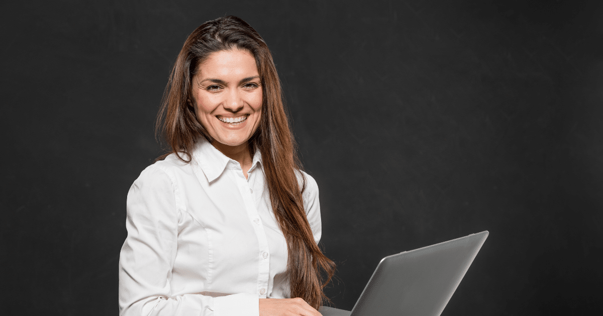 Smiling businesswoman with laptop, exploring financing options for small business success and growth.