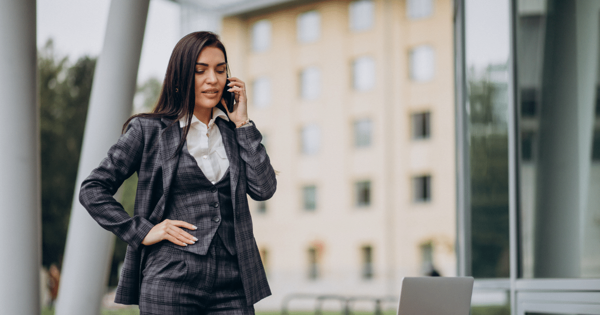 Businesswoman in a suit on the phone, representing strategies for business growth and expansion.