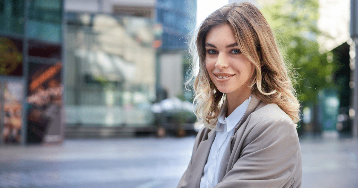 Smiling professional woman in a city setting, promoting team building and productivity through strategic breaks and play-time.